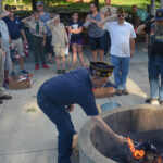 Post 594 Flag Day 2017 - The flags are prepared for burning while members salute. Post 594 Flag Day 2017