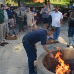 Post 594 Flag Day 2017 - The flags are prepared for burning while members salute. Post 594 Flag Day 2017