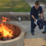 Post 594 Flag Day 2017 - A very large flag is prepared for burning. Post 594 Flag Day 2017 - The flags are prepared for burning while members salute.